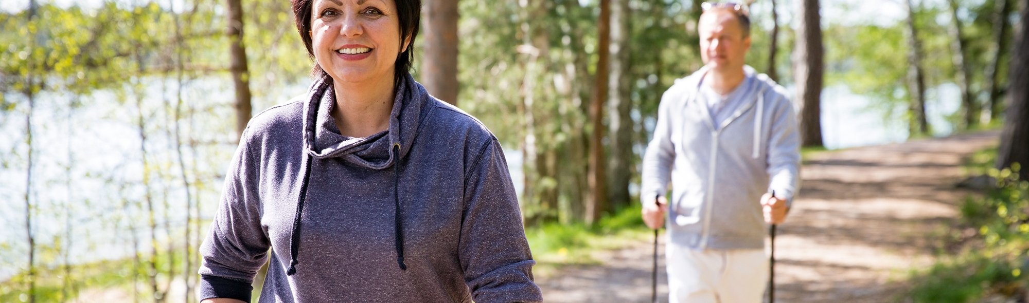 man and a woman walking on a trail 